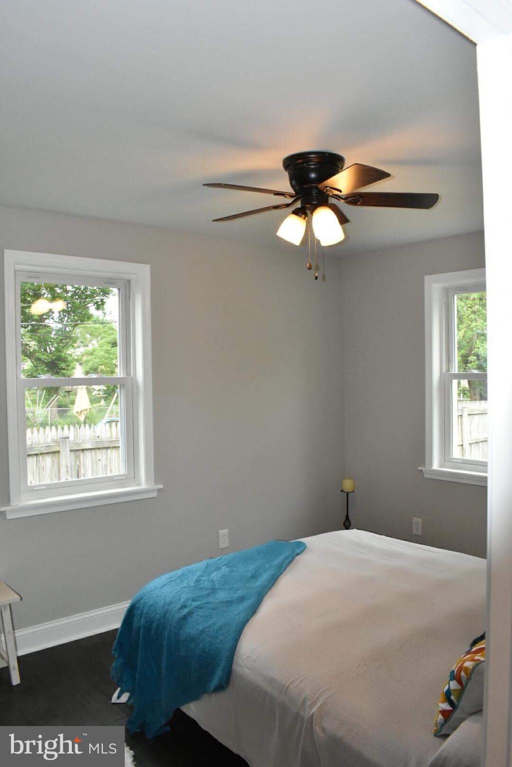 238 Pinewood Road Baltimore, MD 21222 - Photo 17 of 22 a bedroom with a bed and a chandelier fan