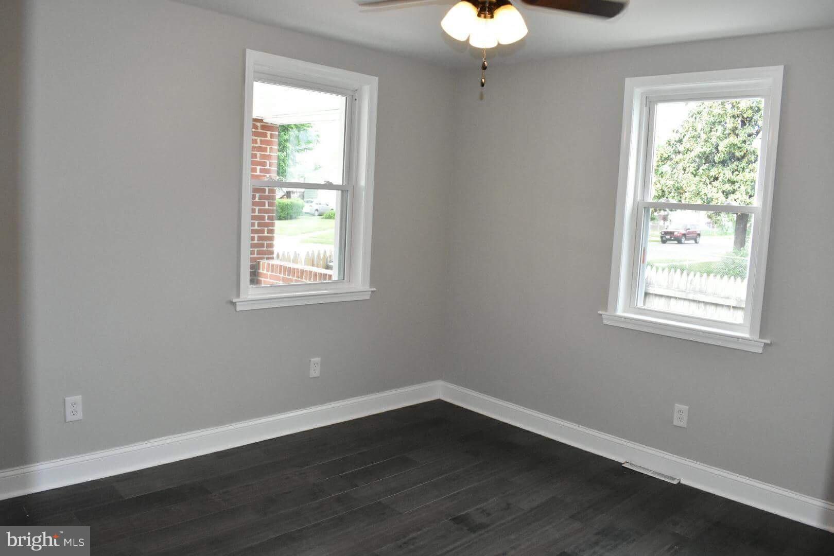 238 Pinewood Road Baltimore, MD 21222 - Photo 18 of 22 a view of an empty room with wooden floor and a window