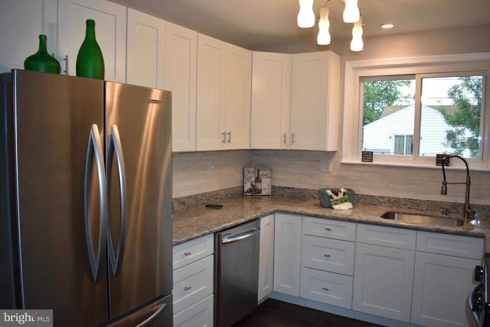 238 Pinewood Road Baltimore, MD 21222 - Photo 7 of 22 a kitchen with stainless steel appliances a refrigerator sink and cabinets