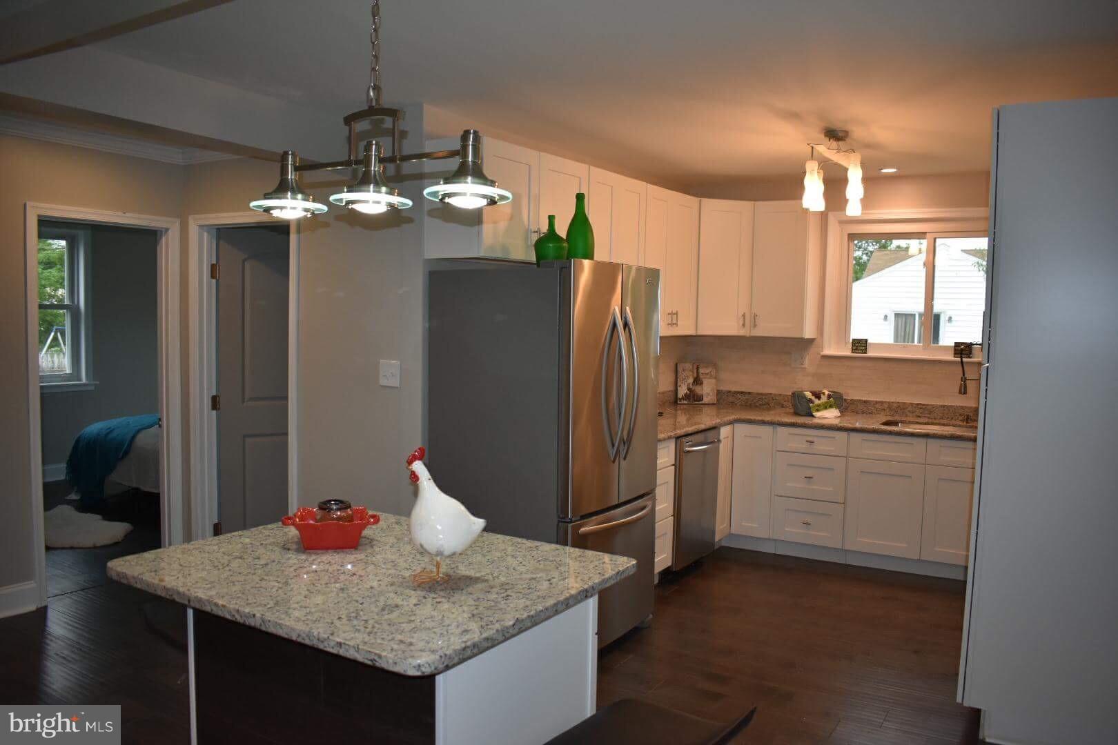 238 Pinewood Road Baltimore, MD 21222 - Photo 8 of 22 a kitchen with stainless steel appliances granite countertop cabinets sink and refrigerator