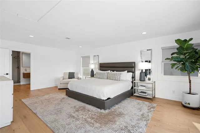 a spacious bathroom with a bathtub sink mirror and toilet
