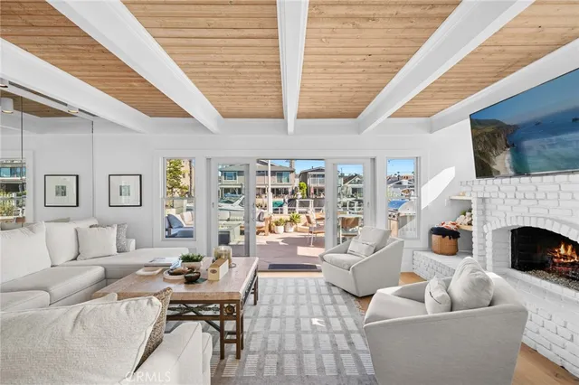 a living room with furniture fireplace and a large window