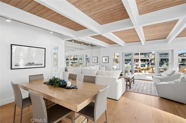 a kitchen with stainless steel appliances kitchen island granite countertop a table and chairs in it
