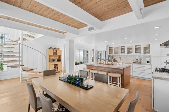 a kitchen with stainless steel appliances kitchen island granite countertop a stove and cabinets