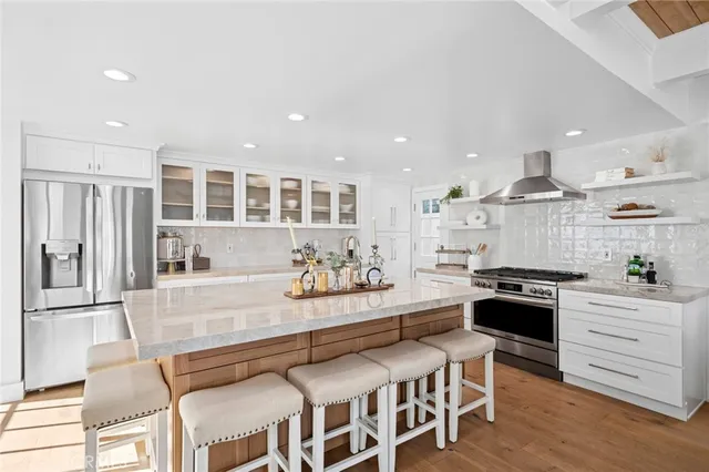 a spacious bedroom with a bed a couch and large window