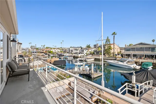 a bedroom with a large bed and a potted plant