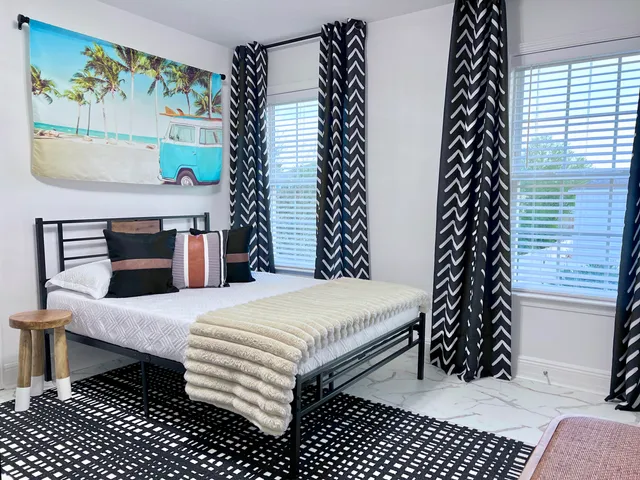 a bedroom with a bed and a window