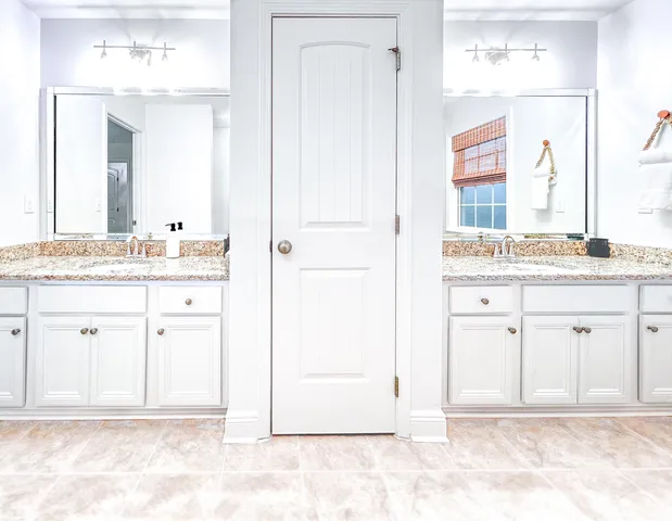 a bathroom with a sink vanity and a mirror