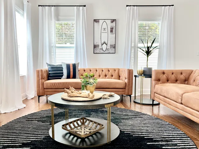 a living room with furniture a table and a window