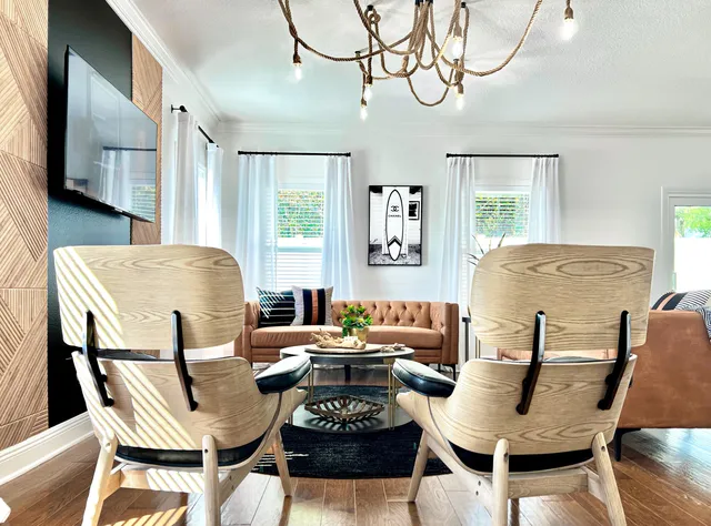 a living room with furniture a large window and a table