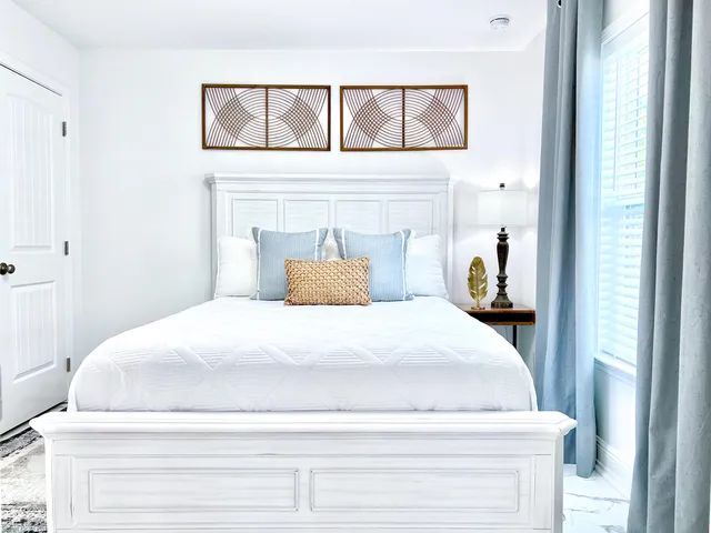 a bedroom with a bed and a window