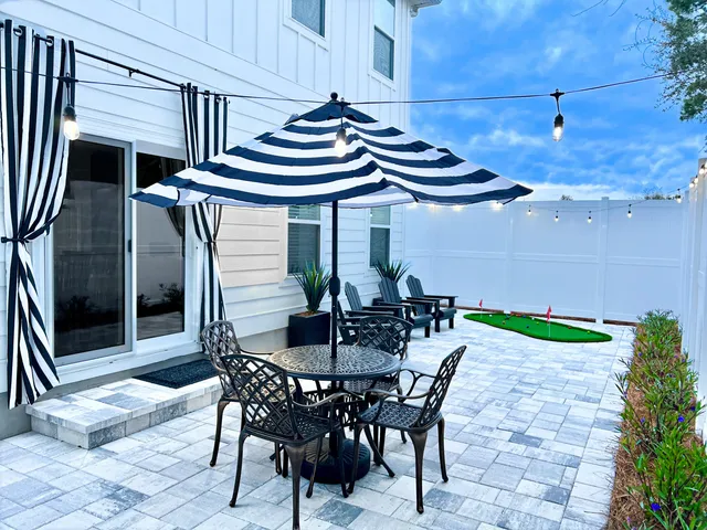 a view of an outside dining space with furniture