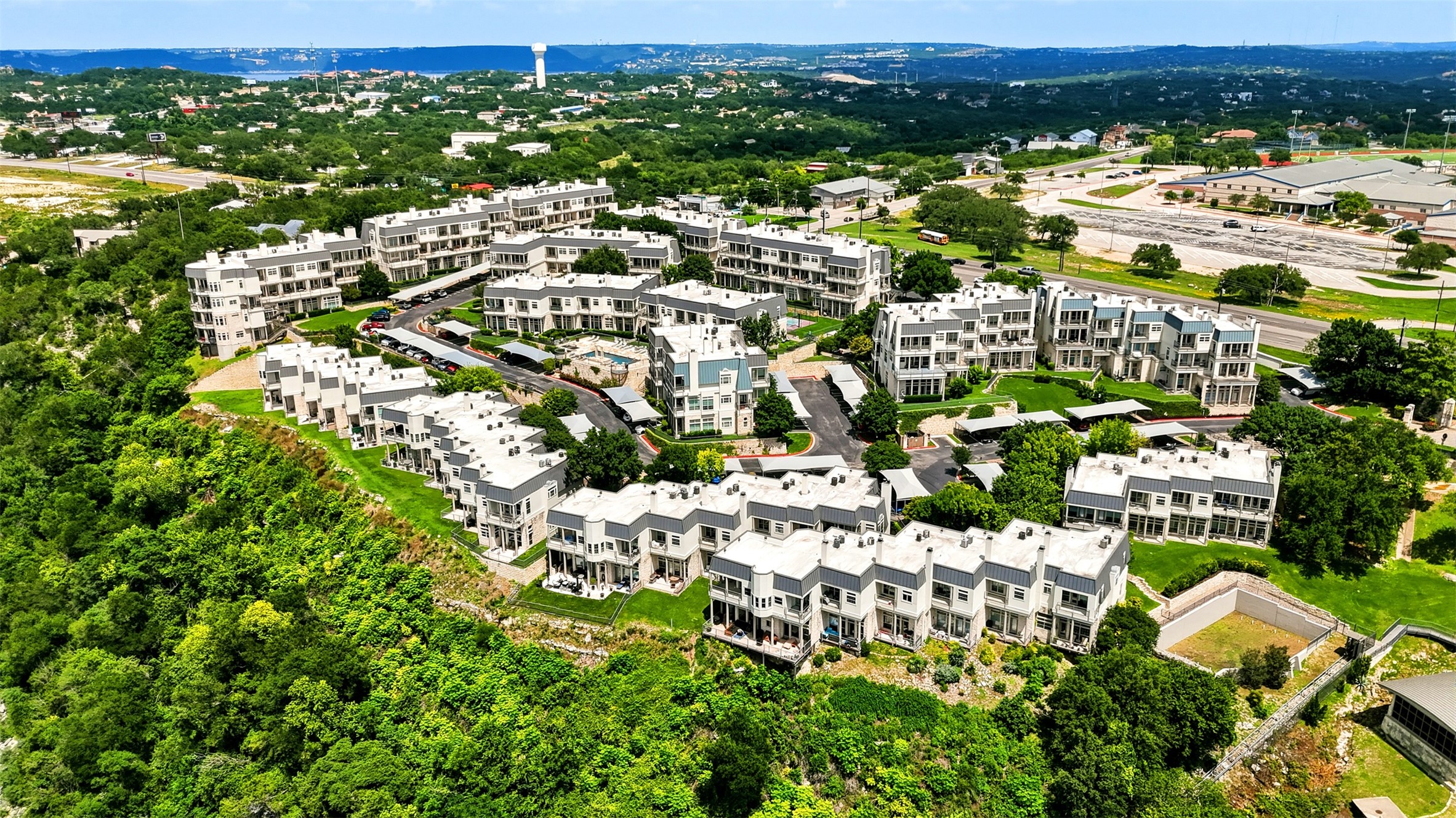 2918 Ranch Road 620, Unit 265 Austin, TX 78734 - Photo 39 of 40 An aerial panorama reveals a dynamic residential community nestled amongst vibrant greenery with captivating views.