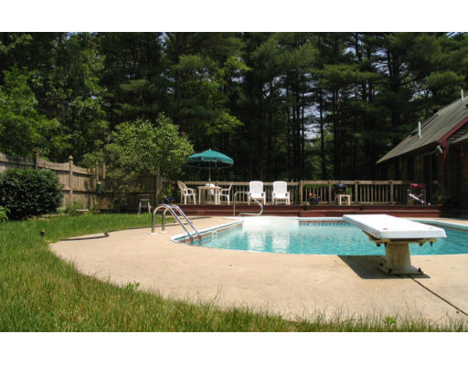 609 Marys Pond Road Rochester, MA 02770 - Photo 2 of 18 a view of a swimming pool with an outdoor space and seating area