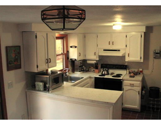 609 Marys Pond Road Rochester, MA 02770 - Photo 8 of 18 a kitchen with a stove a sink a refrigerator and cabinets
