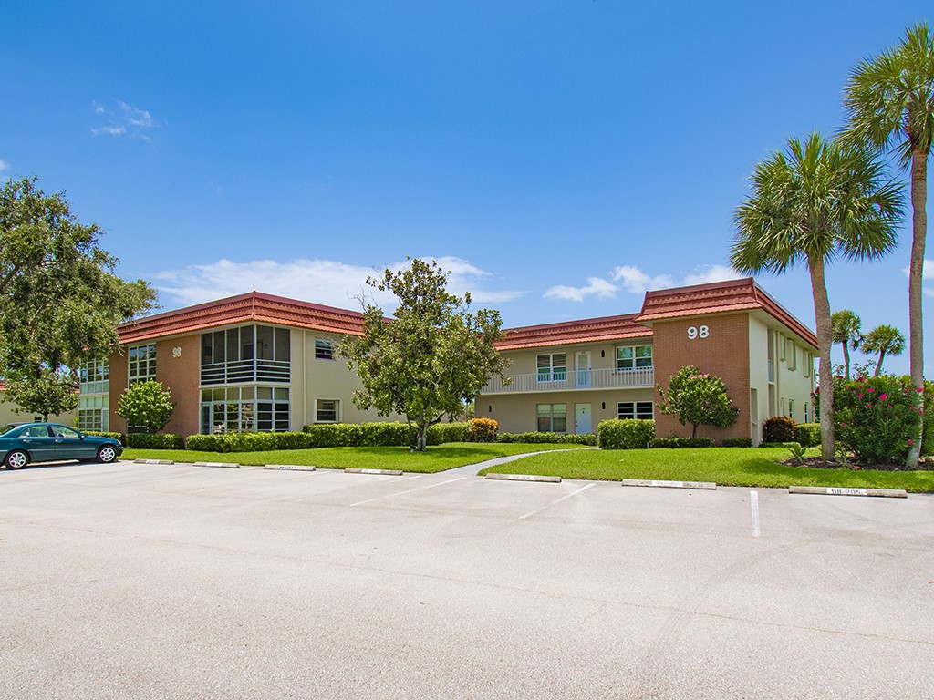 Undisclosed Address Vero Beach, FL 32962 - Photo 1 of 31 a front view of a house with a yard and trees
