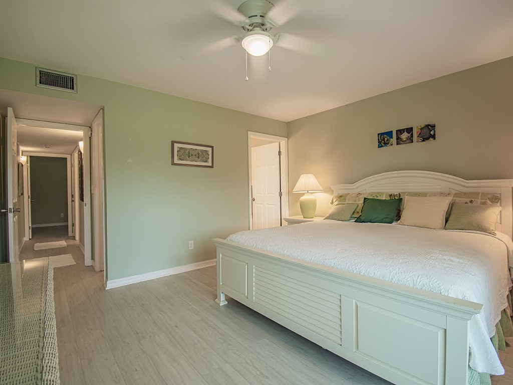 Undisclosed Address Vero Beach, FL 32962 - Photo 17 of 31 a bedroom with a bed and a chandelier