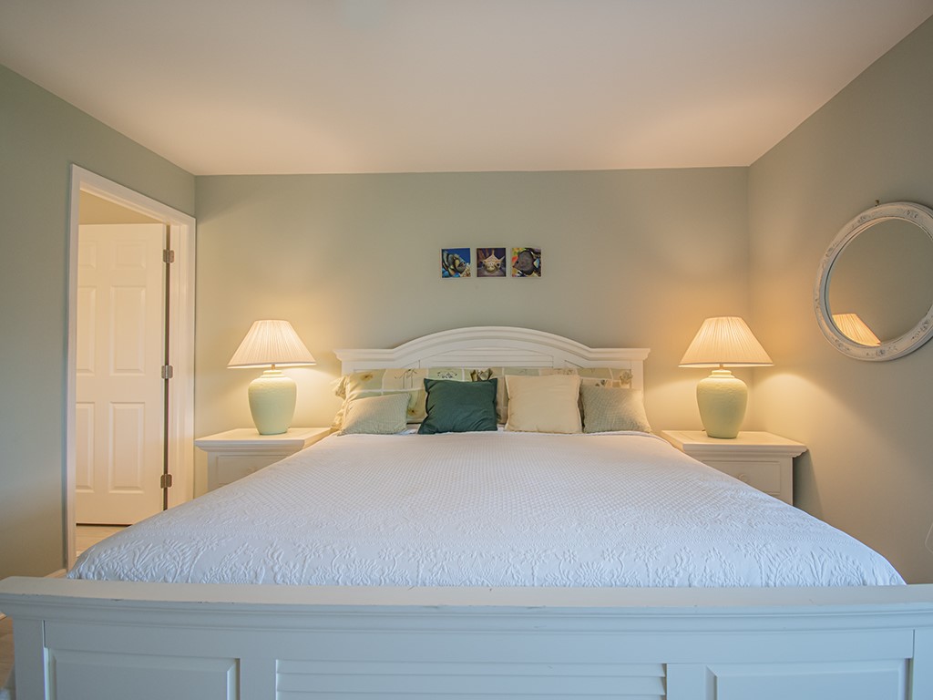 Undisclosed Address Vero Beach, FL 32962 - Photo 18 of 31 a bedroom with a bed and a lamp