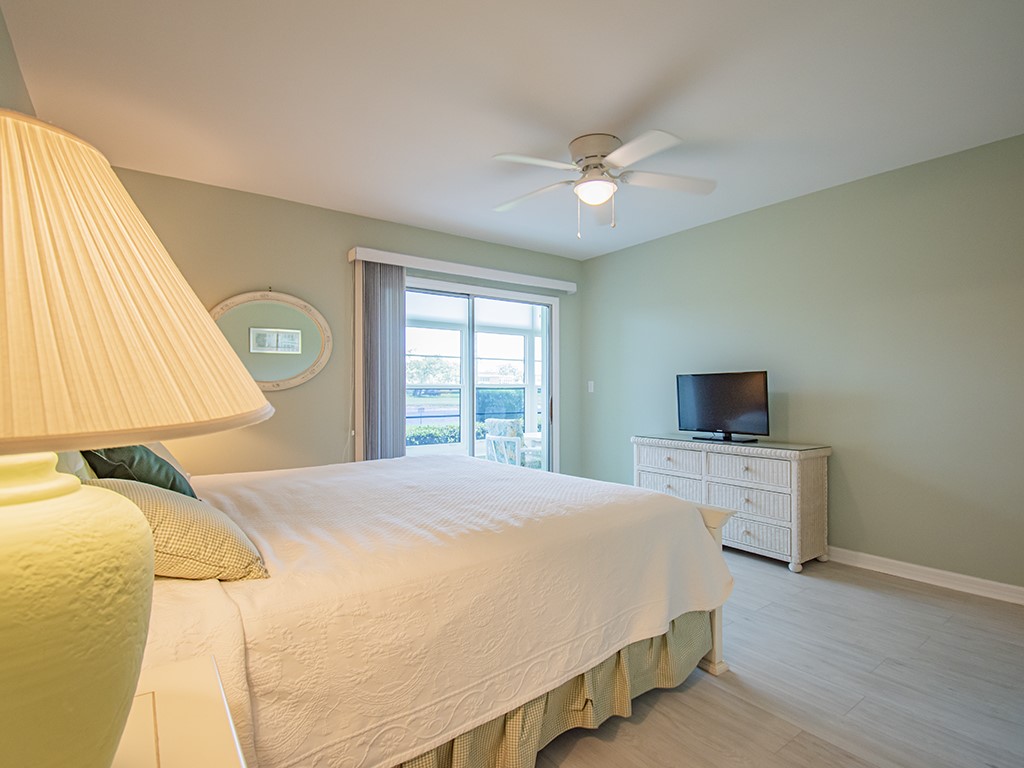 Undisclosed Address Vero Beach, FL 32962 - Photo 19 of 31 a bedroom with a bed and a flat tv screen on dresser