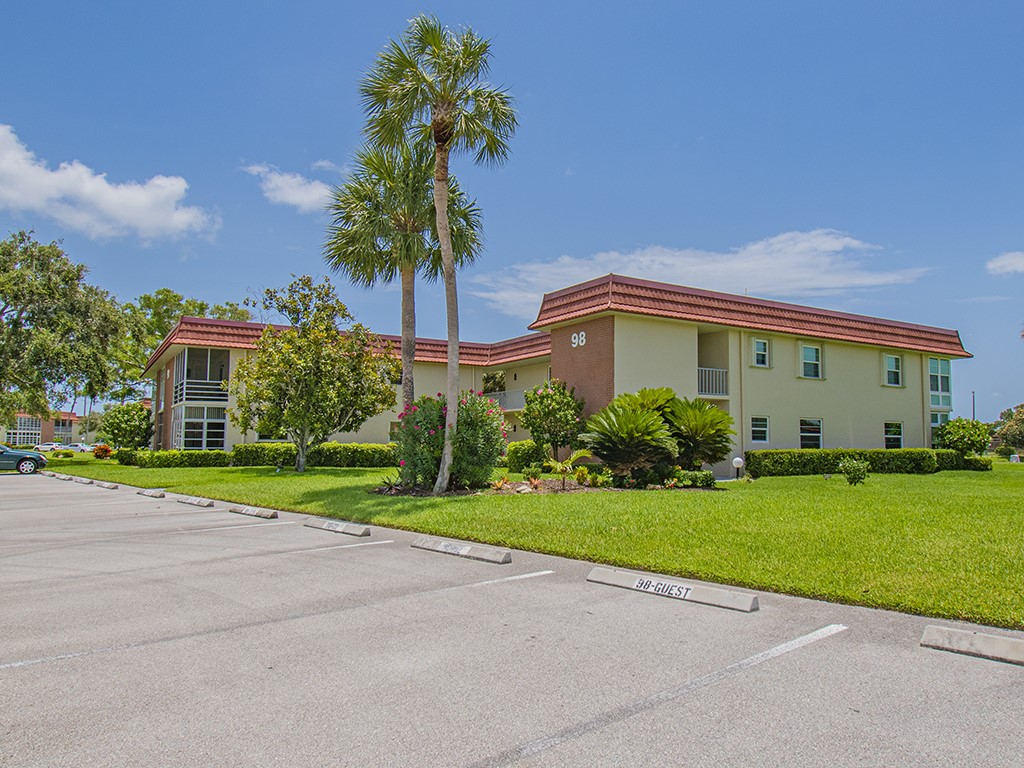 Undisclosed Address Vero Beach, FL 32962 - Photo 2 of 31 a front view of a house with garden