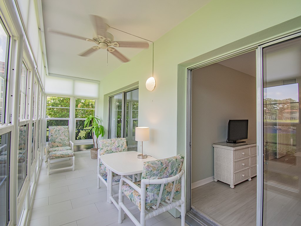 Undisclosed Address Vero Beach, FL 32962 - Photo 21 of 31 a living room with a flat screen tv and a floor to ceiling window