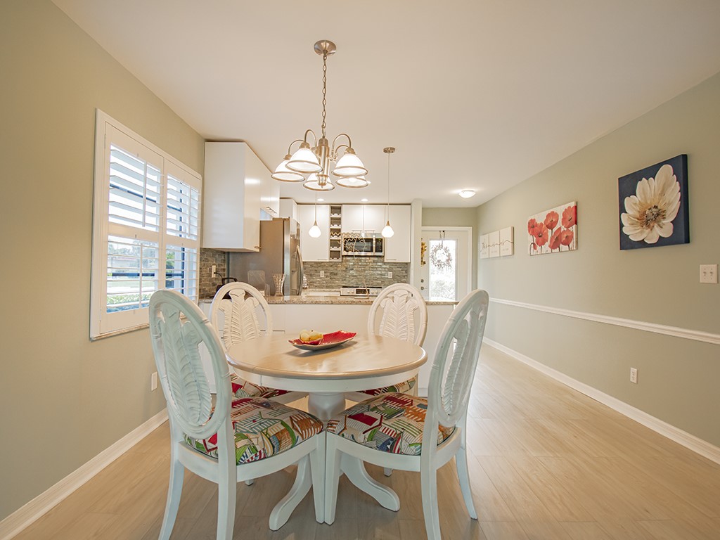 Undisclosed Address Vero Beach, FL 32962 - Photo 7 of 31 a dining room with furniture a chandelier and window