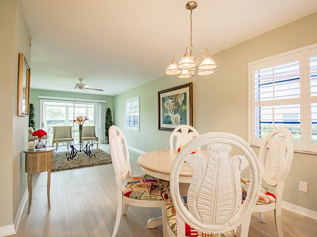 Undisclosed Address Vero Beach, FL 32962 - Photo 8 of 31 a dining room with furniture a chandelier and wooden floor