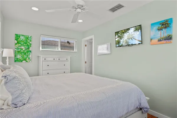 a bedroom with a large bed and a window