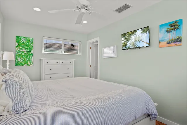 a bedroom with a large bed and a window