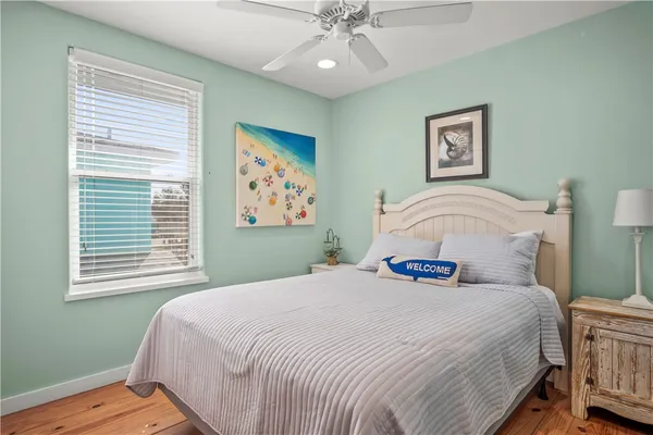 a bedroom with a large bed and a window