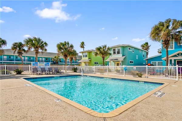 swimming pool view with a garden space