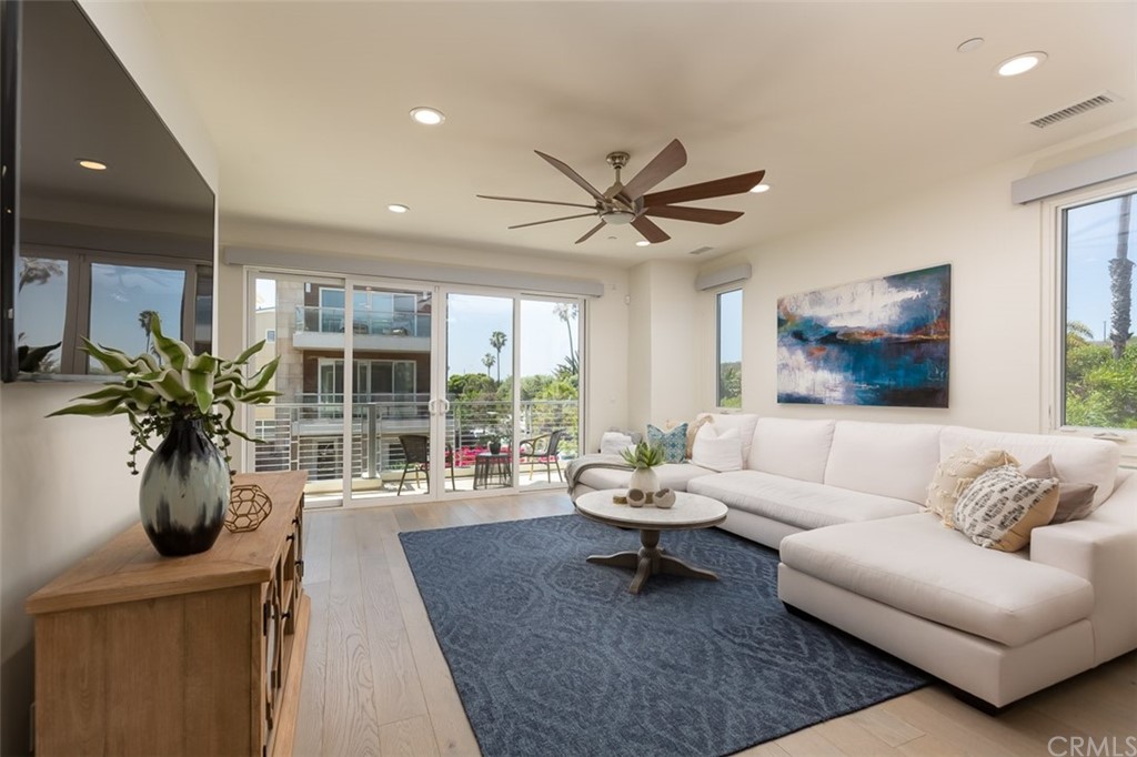 5505 River Avenue Newport Beach, CA 92663 - Photo 2 of 40 a living room with furniture and a potted plant