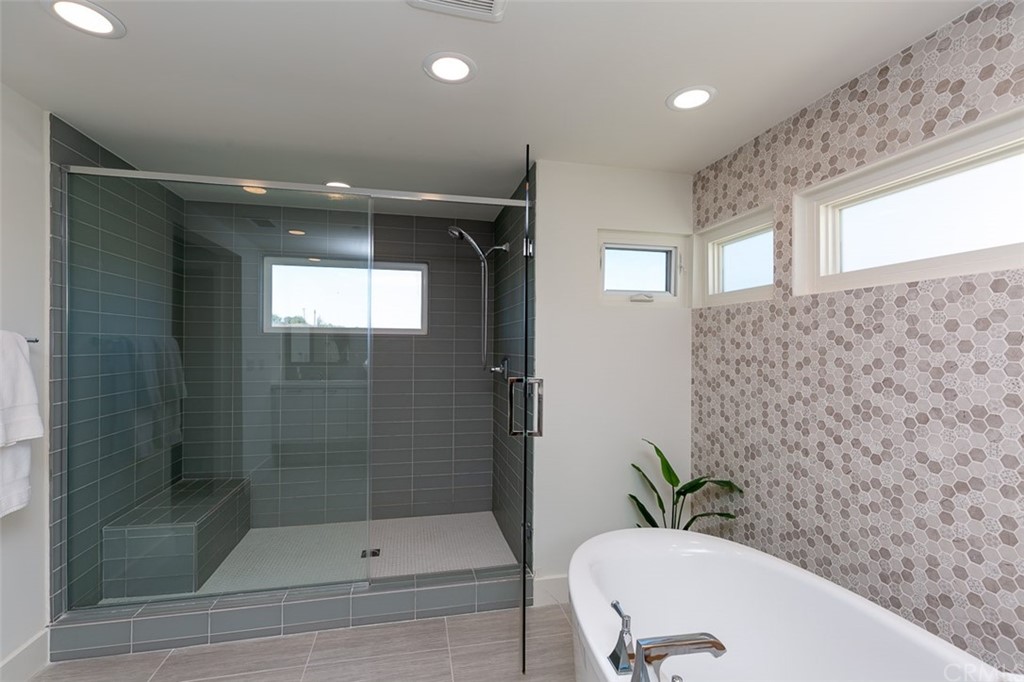 5505 River Avenue Newport Beach, CA 92663 - Photo 13 of 40 a bathroom with a shower curtain and a sink