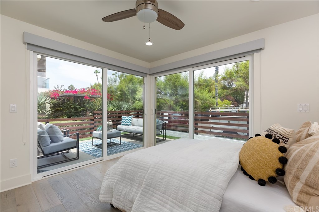 5505 River Avenue Newport Beach, CA 92663 - Photo 15 of 40 a bed room with a bed and a large window