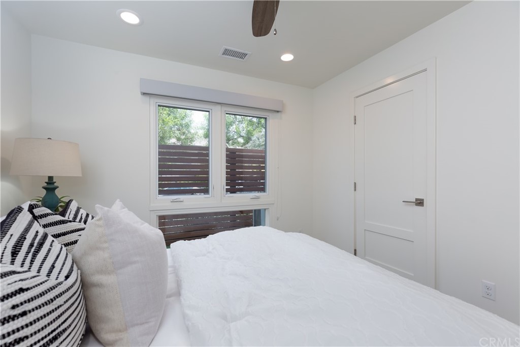 5505 River Avenue Newport Beach, CA 92663 - Photo 20 of 40 a bedroom with a large bed and a large window