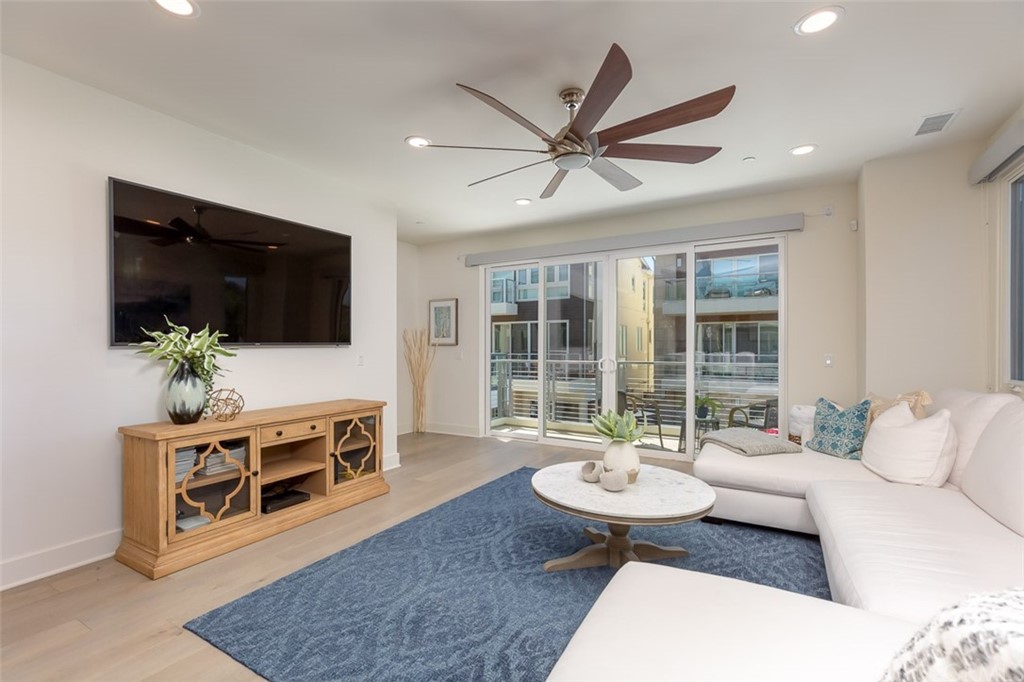5505 River Avenue Newport Beach, CA 92663 - Photo 3 of 40 a living room with furniture and a flat screen tv