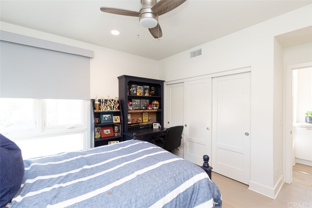 5505 River Avenue Newport Beach, CA 92663 - Photo 23 of 40 a bedroom with a bed and a cabinets