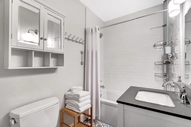 a bathroom with a sink toilet and shower