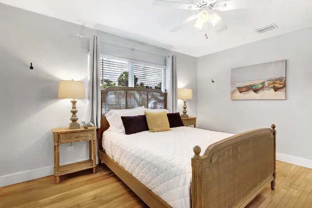 a bedroom with a large bed and a chandelier