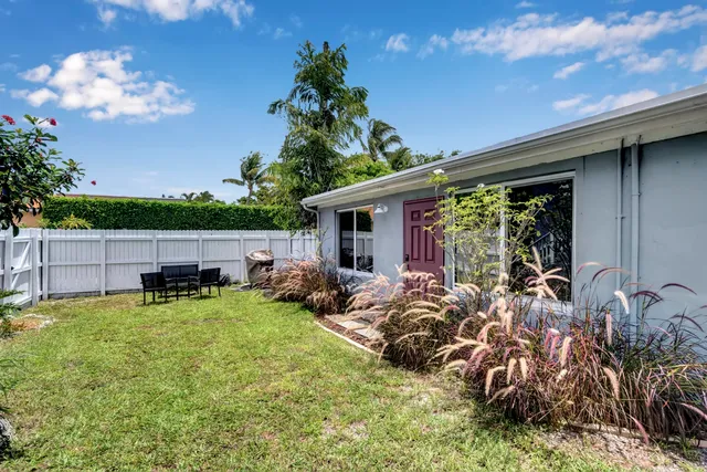 a view of a chair and table in backyard of the house