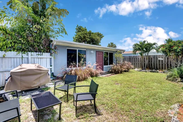 a view of a house with backyard and sitting area