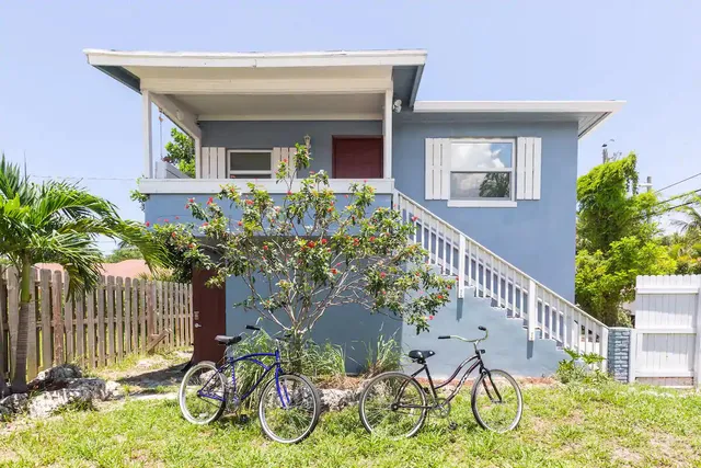 a view of an house with backyard and sitting area