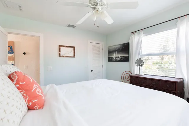 a bedroom with a large bed and a window