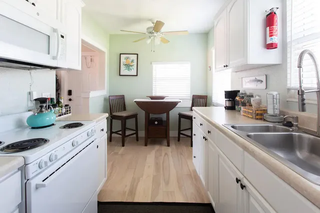 a kitchen with a sink cabinets and window