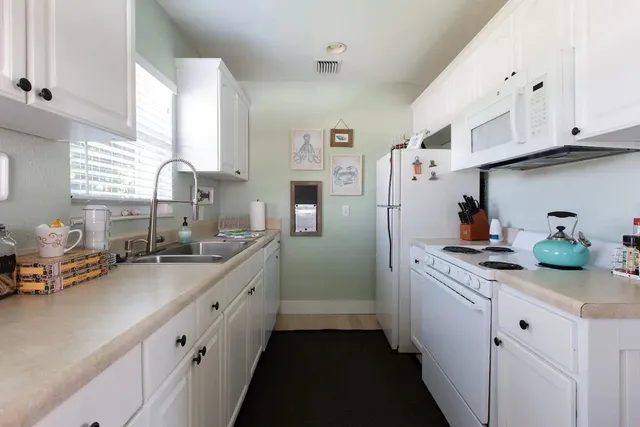 a kitchen with stainless steel appliances a sink stove and refrigerator