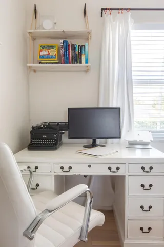 a room with a couch and a bookshelf