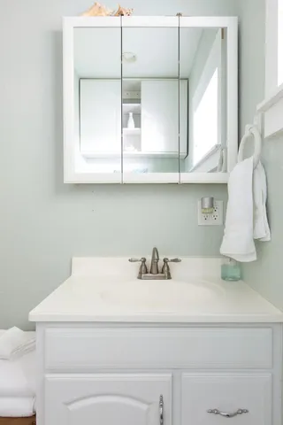 a bathroom with a sink and a mirror