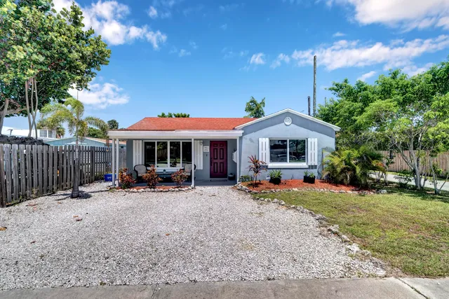 a view of a house with a yard patio and furniture