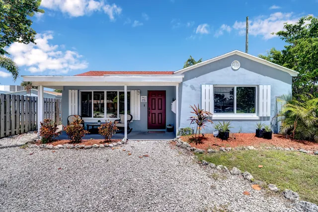a view of a house with sitting area and garden