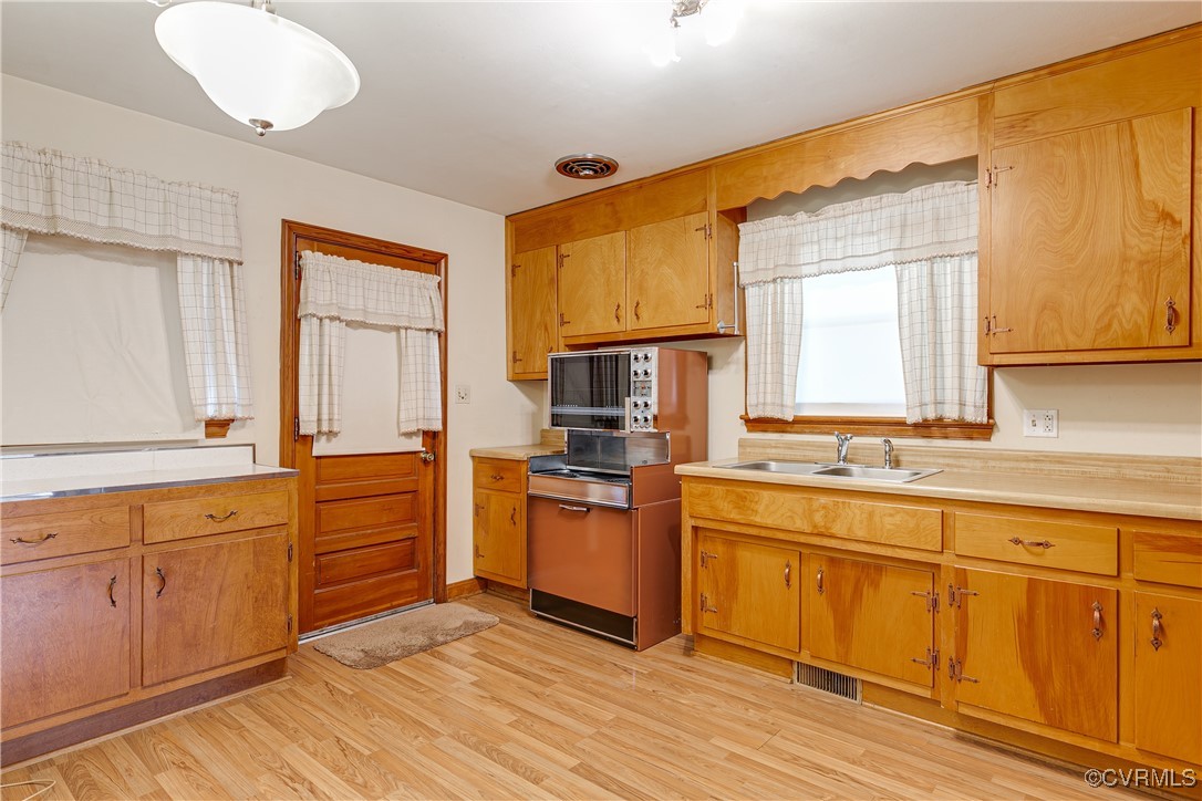 3307 Walnut Street Hopewell, VA 23860 - Photo 18 of 38 a kitchen with stainless steel appliances granite countertop a stove a sink and a refrigerator